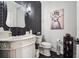 Bathroom featuring black herringbone wall, hexagon tiles, and a decorative print at 6060 Masters Club Dr, Suwanee, GA 30024