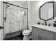 Modern bathroom featuring a glass shower door, black fixtures, and marble countertop at 6060 Masters Club Dr, Suwanee, GA 30024