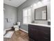 Bathroom with a stand-up shower, vanity, and wood-style flooring with a window for ample natural light at 6060 Masters Club Dr, Suwanee, GA 30024