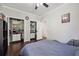 This bedroom features a ceiling fan, carpet floors and two large closets at 6060 Masters Club Dr, Suwanee, GA 30024