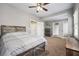 Spacious bedroom with ceiling fan, carpeted floors, and ensuite bathroom and walk-in closet entrances at 6060 Masters Club Dr, Suwanee, GA 30024