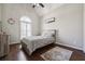 A bedroom featuring vaulted ceilings, a modern ceiling fan, and a large window with plantation shutters at 6060 Masters Club Dr, Suwanee, GA 30024