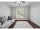 Cozy bedroom features a soft couch and rug, and a large window overlooking trees at 6060 Masters Club Dr, Suwanee, GA 30024