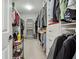 Walk-in closet featuring built-in shelving, hanging rods, and carpet at 6060 Masters Club Dr, Suwanee, GA 30024