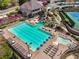An aerial view of the community pool includes a slide, tables, and plenty of seating at 6060 Masters Club Dr, Suwanee, GA 30024