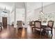 Open concept dining area featuring hardwood floors and natural light from the surrounding windows at 6060 Masters Club Dr, Suwanee, GA 30024