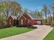 Well-maintained brick home with a long driveway and beautiful landscaping at 6060 Masters Club Dr, Suwanee, GA 30024