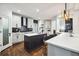Stylish kitchen with white cabinets, an island with a sink, and modern light fixtures at 6060 Masters Club Dr, Suwanee, GA 30024