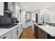 Well-lit kitchen showcasing white cabinetry, stainless steel appliances, and a contrasting dark island at 6060 Masters Club Dr, Suwanee, GA 30024
