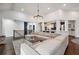 Spacious living room with a large sectional sofa, views of the kitchen, and modern lighting at 6060 Masters Club Dr, Suwanee, GA 30024