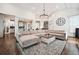 Cozy living room featuring a large sectional sofa and views into the kitchen at 6060 Masters Club Dr, Suwanee, GA 30024