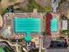 Aerial view of a large community pool and kiddie pool, with lounge chairs, tables and mature landscaping at 6060 Masters Club Dr, Suwanee, GA 30024