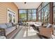 Relax on this screened porch with comfortable seating, a ceiling fan, and a view of mature trees at 6060 Masters Club Dr, Suwanee, GA 30024