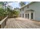 Wide wooden deck, attached to the house with white french doors, offering ample space for outdoor activities at 9992 Neuchatel Cres, Jonesboro, GA 30238