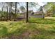 Expansive backyard with mature trees, lush greenery, and a spacious deck for outdoor gatherings at 9992 Neuchatel Cres, Jonesboro, GA 30238