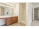 Bathroom with a shower, a vanity with wood cabinets, and a large mirror at 9992 Neuchatel Cres, Jonesboro, GA 30238
