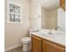 Bathroom featuring a toilet and sink, with a view of the tub/shower and a window at 9992 Neuchatel Cres, Jonesboro, GA 30238