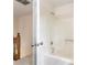 Bathroom featuring a shower/tub, neutral walls, and a view of the stairway landing at 9992 Neuchatel Cres, Jonesboro, GA 30238