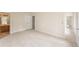 Spacious bedroom with neutral carpet, white trim, and access to the bathroom and another room at 9992 Neuchatel Cres, Jonesboro, GA 30238