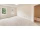 Inviting bedroom with plush carpet, natural light, and a bathroom with a garden tub at 9992 Neuchatel Cres, Jonesboro, GA 30238