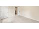 Bedroom with neutral walls and carpet, and two white doors leading to other rooms at 9992 Neuchatel Cres, Jonesboro, GA 30238