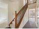 Traditional foyer showcasing hardwood floors, carpeted stairs, and natural light at 9992 Neuchatel Cres, Jonesboro, GA 30238