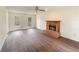Spacious living room features a brick fireplace, hardwood flooring, and large windows at 9992 Neuchatel Cres, Jonesboro, GA 30238