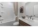 Clean, well-lit bathroom with a shower-tub combination, wooden vanity, and neutral decor at 1105 Rivard Nw Cir, Atlanta, GA 30318