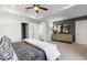 Spacious bedroom featuring a modern grey wall, plush carpet, dresser with mirror, and an entry into a walk-in closet at 1105 Rivard Nw Cir, Atlanta, GA 30318