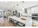 Open kitchen with a huge center island, stylish pendant lights, and stainless steel appliances at 1105 Rivard Nw Cir, Atlanta, GA 30318
