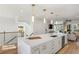 Kitchen island features a breakfast bar, sink, and modern white cabinets at 1105 Rivard Nw Cir, Atlanta, GA 30318