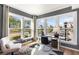 Bright home office featuring three large windows, modern decor, and a comfortable workspace with ample natural light at 1105 Rivard Nw Cir, Atlanta, GA 30318