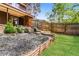 Landscaped backyard with retaining walls, garden, and a lush lawn at 1603 Circlestone Dr, Stone Mountain, GA 30088