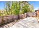 Fenced backyard featuring a concrete slab and gateway at 1603 Circlestone Dr, Stone Mountain, GA 30088