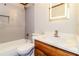 Updated bathroom with a single sink vanity, backlit mirror, and modern tiled shower-tub combo at 1603 Circlestone Dr, Stone Mountain, GA 30088