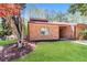 Well-maintained brick home with lush green lawn and mature tree in the front yard at 1603 Circlestone Dr, Stone Mountain, GA 30088
