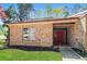Charming single story brick home with a manicured lawn and inviting red front door at 1603 Circlestone Dr, Stone Mountain, GA 30088
