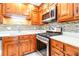 Modern kitchen showcasing stainless steel appliances, light countertops, and ample wood cabinetry at 1603 Circlestone Dr, Stone Mountain, GA 30088