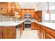 Well-lit kitchen featuring stainless steel appliances, updated backsplash, and a convenient island at 1603 Circlestone Dr, Stone Mountain, GA 30088