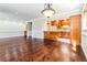 Open living area with hardwood floors, decorative lighting, and a view into the adjacent kitchen at 1603 Circlestone Dr, Stone Mountain, GA 30088