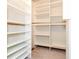 Spacious walk-in closet with carpeted floors and built-in shelving for organized storage at 1603 Circlestone Dr, Stone Mountain, GA 30088