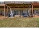 Backyard view featuring a covered patio with furniture and a grassy area at 1829 Appaloosa Mill Ct, Buford, GA 30519