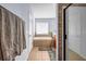 Bathroom featuring a bathtub, tiled walls and floor, and natural light at 1829 Appaloosa Mill Ct, Buford, GA 30519