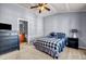 This bedroom offers neutral carpet, a ceiling fan and access to an ensuite bathroom at 1829 Appaloosa Mill Ct, Buford, GA 30519