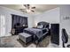 A bedroom with a ceiling fan, dark-colored furniture, and a patterned tile floor at 1829 Appaloosa Mill Ct, Buford, GA 30519