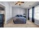 Spacious carpeted bedroom with a ceiling fan and great natural light from two windows at 1829 Appaloosa Mill Ct, Buford, GA 30519
