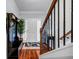 Entryway with wood floors, staircase with black iron railings, and coat rack at 1829 Appaloosa Mill Ct, Buford, GA 30519