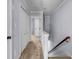 Upstairs hallway with carpet, white doors, and a view into another room at 1829 Appaloosa Mill Ct, Buford, GA 30519