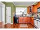 Kitchen with wood cabinets, granite counters, stainless appliances, and hardwood flooring at 1829 Appaloosa Mill Ct, Buford, GA 30519