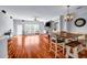 Open-concept living room and dining area, featuring hardwood floors and a stone fireplace at 1829 Appaloosa Mill Ct, Buford, GA 30519